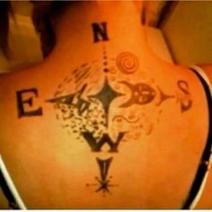 a woman with a compass tattoo on her back