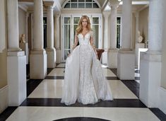 a woman in a white wedding dress standing on a black and white checkered floor