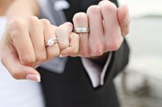 black and white photograph of a woman holding her engagement ring in one hand with the other