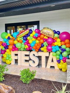 there is a sign that says fiesta with balloons all over the front and side of it