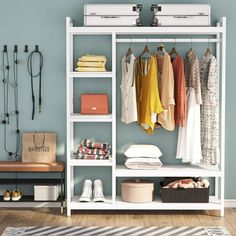 an organized closet with clothes, shoes and other items hanging on the wall in front of it