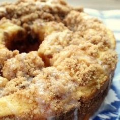 a close up of a donut on a plate with icing and crumbs