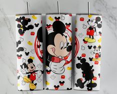 three mickey mouse towels hanging on a rack