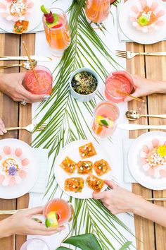 people sitting at a table with food and drinks on plates in the shape of a christmas tree