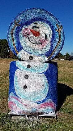 a snowman statue in the middle of a field