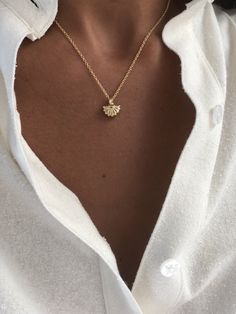 The Mini Shell Pendant necklace is a petite and elegant staple for layering and is perfect for summer lovers to wear year round to remind them of favorite beach days. Pendant is cast in brass and 14k gold plate. The pendant and bail are one unit. Chains are metal and 14k gold filled. Made in the USA Measurements: .5" length (with bail) / .5" width / .125" depth pendant 18" length / 1.2mm venetian box chain or 16" / 1.5mm link chain *Listing is for one individual necklace with pendant - some phot Elegant Luxury Shell Pendant Necklace, Couple Ring Finger Tattoos, Ring Tattoo Designs, Buy Earrings Online, Ring Finger Tattoos, Gems Bracelet, Buy Earrings, Simple Engagement Rings, Gold Bracelet For Women