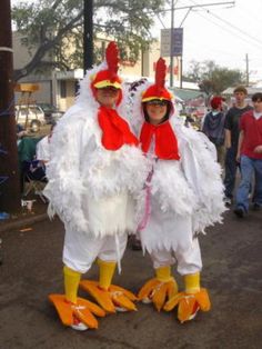 two people dressed in chicken costumes on the street