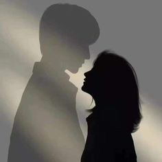 the shadow of a man and woman kissing