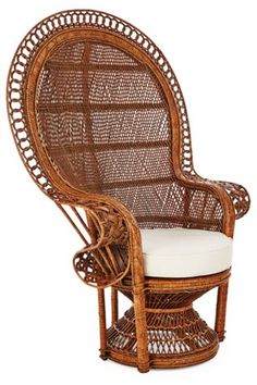 a wicker chair with a cushion on it's back and armrests