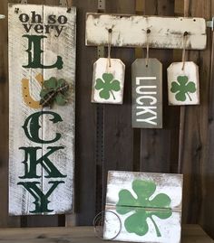 two wooden signs with shamrocks hanging from them on a wall next to a sign that says luck and lucky