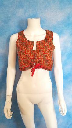 "A splendid, mystical crop top from the 60s or 70s. I suspect it was made in India. Bright, canvas-like-but-softer somewhat coarsely woven fabric, with a split neckline and unique half-circle drawstring tightener at the front with red cotton tape drawstring. Printed with a rich pattern of ornate paisley in gold and black, on a persimmon red background. Very good vintage condition, with a tiny bit of fading here and there. Decade: 1960s or 1970s Label: none, but probably made in India Material: c 70s Inspired Fashion, Half Circle, Cropped Tube Top, 70s Inspired, Sleeveless Crop Top, Inspired Fashion, Red And Yellow, Vintage 60s, Red Background