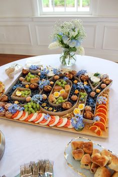 a table topped with lots of food on top of a white tablecloth covered table