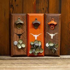 three wooden blocks with different designs on them and one is painted orange, the other has an animal's head