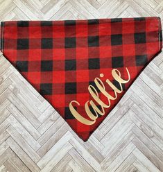 a red and black plaid bandana with the word cali in gold on it