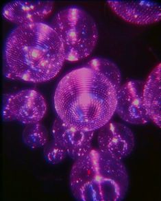 purple bubbles floating in the air on a black background