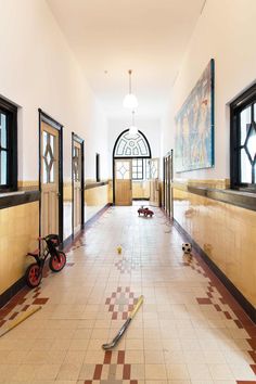 an empty hallway with several pieces of art on the floor