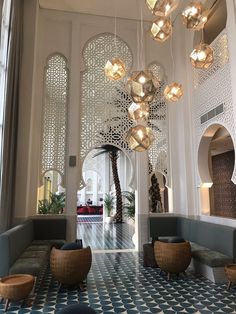 the lobby is decorated with modern furniture and chandeliers