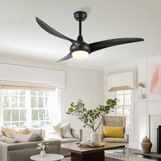 a living room with a couch, coffee table and ceiling fan in the middle of it