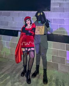 two people dressed in costumes standing next to each other