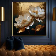 two white flowers on a black background in a living room with blue walls and gold accents