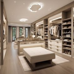 a large walk in closet with white furniture