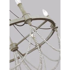 a chandelier with white beads hanging from it's sides and two lights on each side