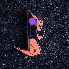 a pin with an image of a woman holding a surfboard in her hands on a black surface