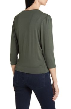 Cut from a soft, drapey jersey knit with an easy faux-wrap design, this top is an ideal choice for both casual looks or more styled up outfits. 23" length Surplice V-neck Three-quarter sleeves 95% rayon, 5% spandex Machine wash, dry flat Imported Solid Color V-neck Faux Wrap Top, Versatile Stretch Wrap Top, Solid V-neck Faux Wrap Top, Faux Wrap V-neck Top, Casual Rayon Tops With 3/4 Sleeves, Faux Wrap Tops For Layering In Spring, Spring Faux Wrap Tops For Layering, Chic Soft Stretch Tops For Layering, Chic Relaxed Fit Tops Made Of Modal