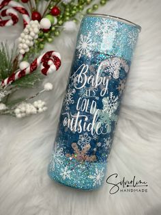 a blue glitter tumbler with the words baby it's cold outside