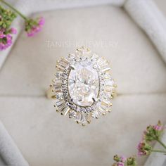 an oval shaped diamond surrounded by small flowers