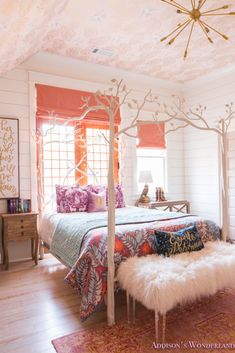 a bed room with a canopy bed and a white rug on the floor next to a window