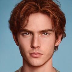 a young man with red hair and blue eyes