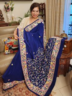 Update! - Zynah covered by LBB - https://lbb.in/bangalore/zynah-designs-handloom-sarees/ Elevate your style quotient with our Navy Blue Pure Crepe Silk Hand Embroidered Parsi Gara Saree, a stunning piece of authentic vintage art that is sure to make you stand out. Adorned with intricate nature-inspired motifs and multi-color thread embroidery, this saree boasts of a beautiful combination of small colorful floral butis in the body. The saree features a double layer of embroidery to create a uniqu Designer Wear Blue Fabric With Intricate Embroidery, Blue Bohemian Blouse Piece With Zari Work, Blue Traditional Wear With Intricate Embroidery, Traditional Blue Wear With Intricate Embroidery, Designer Blue Saree With Floral Embroidery, Designer Floral Embroidered Blue Saree, Blue Bollywood Traditional Wear In Silk Thread, Blue Silk Blouse Piece With Floral Embroidery, Festive Blue Traditional Wear In Silk Thread