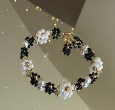 This beautiful white and black floral bracelet is handmade. Would be a great gift for her, a wedding gift. You can make them into matching bridesmaid, bracelets, party favors, and just an every day accessory. If you would like I can customize any colors on the bracelet just send me a message. I offer lengths 5 inches to 9 inches. If you need another size, please let me know and I would love to make it for you. If you do not like the clasp I have other options just let me know when I can send you Handmade Black Flower Bracelets, Black Flower Shaped Beaded Bracelets, Black Flower Bracelets For Gifts, Black Flower Beaded Bracelets For Gift, Black Flower Shaped Beaded Bracelets For Gift, Black Flower Beaded Bracelets, Elegant White Bracelet With Black Beads, Elegant White Bracelets With Black Beads, Beaded Black And White Jewelry Gift