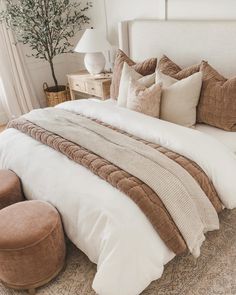 a bed with pillows and blankets on top of it