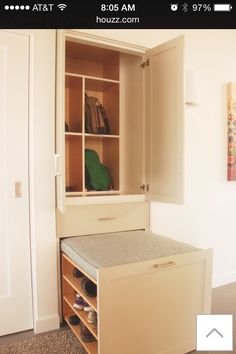 an open cabinet with shoes in it next to a white door and carpeted floor