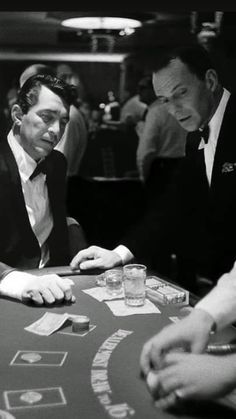 three men sitting at a casino table playing cards