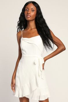 You'll only enhance your beauty when you put on the Lulus Gorgeous Vision White Ruffled Faux-Wrap Mini Dress! Lightweight woven fabric, with subtle texture throughout, shapes adjustable spaghetti straps that support a straight neckline with a unique foldover detail, atop a princess-seamed bodice. Fitted waist tops a faux-wrap skirt with a side tie, falling to a ruffled mini hem. Elastic and hidden zipper/clasp at back. Fit: This garment fits true to size. Length: Mid-thigh. Size medium measures Elegant Sleeveless Mini Dress With Wrap-around Straps, Flirty Tie Waist Wrap Dress For Brunch, Elegant Mini Dress With Knotted Straps For Date Night, Elegant Mini Dress With Spaghetti Straps And Knotted Detail, Elegant Mini Dress With Knotted Spaghetti Straps, Elegant Mini Dress With Spaghetti And Knotted Straps, Flirty Wrap Dress, Elegant Strappy Mini Dress For Brunch, Summer Mini Dress With Wrap-around Spaghetti Straps