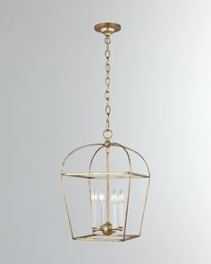 an antique brass cage chandelier hanging from a ceiling