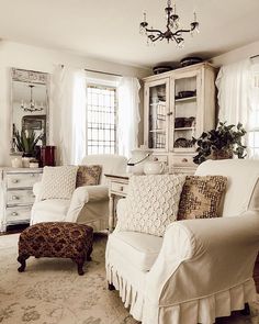 a living room filled with furniture and a chandelier