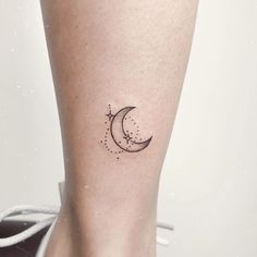 a small moon and star tattoo on the right side of the calf's leg