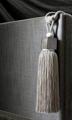 a black suitcase with a tassel hanging from it