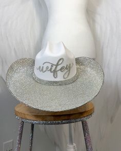 a white hat sitting on top of a wooden stool