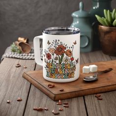 a white coffee mug sitting on top of a wooden table