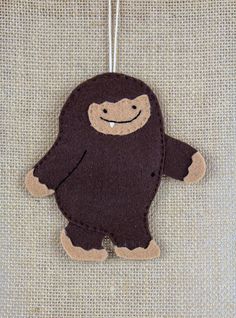 a brown stuffed animal hanging from a string