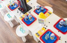 a child's birthday party table set up with water bottles and cups