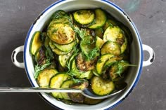 a pot filled with cooked zucchini and herbs