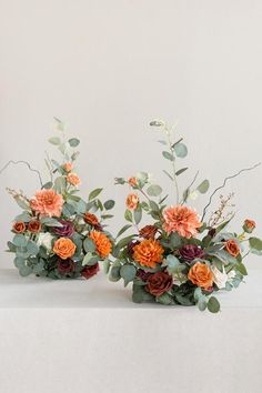 two vases filled with flowers on top of a table