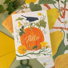 there is a card with a bird on top of it next to scissors and flowers