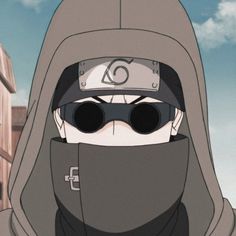 a man wearing sunglasses and a hoodie with the letter o on his face in front of buildings